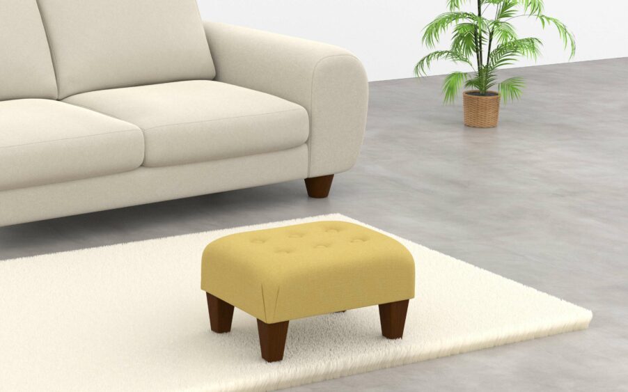 Button footstool upholstered in yellow linen fabric with wood legs